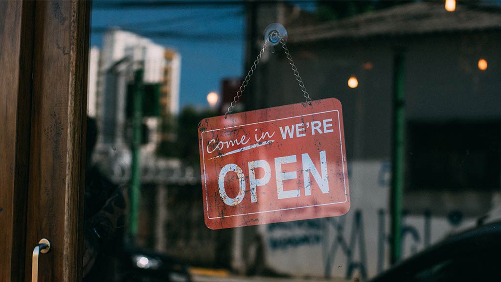 Come in We're Open Sign in business window